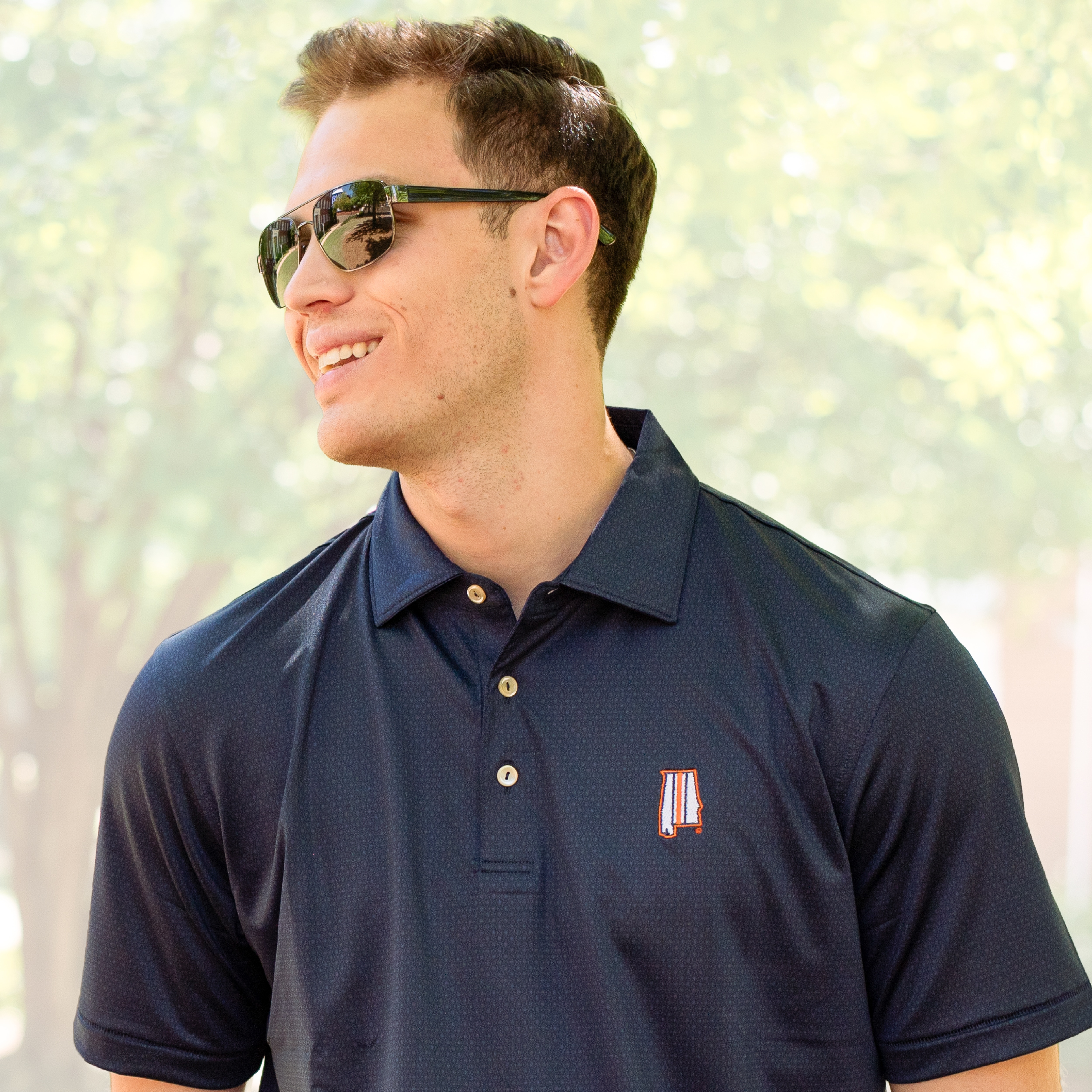 Auburn student wearing an Auburn navy polo